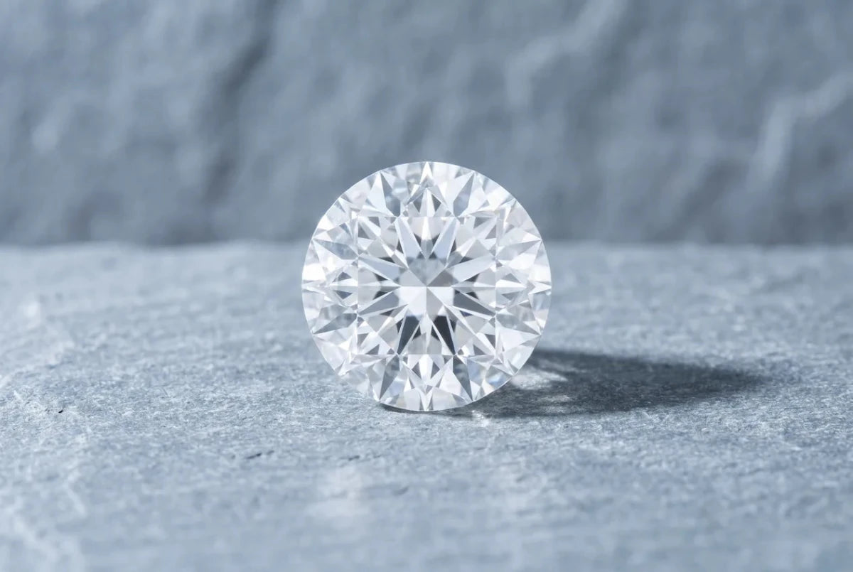 A round brilliant diamond seen from directly above, its crown facets meeting in sharp symmetrical junctions