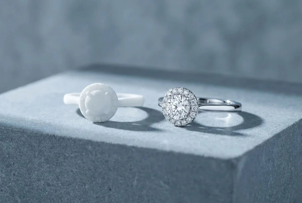 A white resin 3D-printed ring prototype beside the identical finished diamond ring in white gold