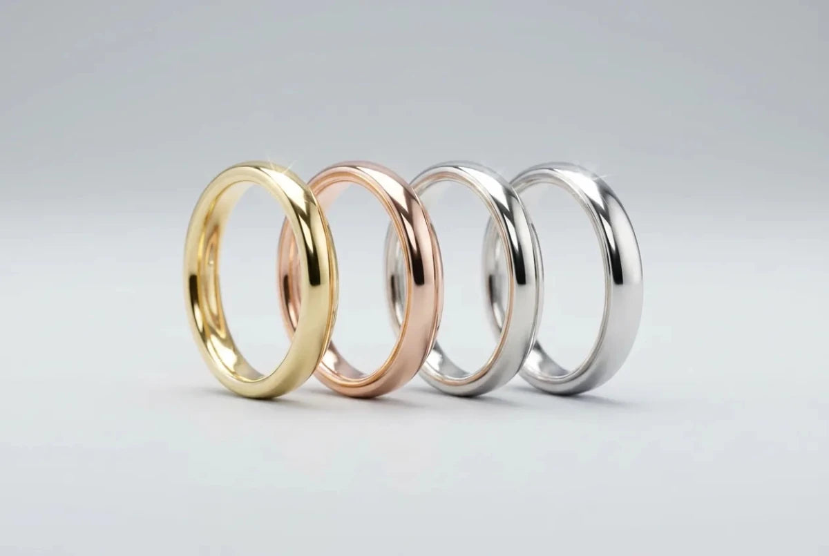 Four plain wedding bands in yellow gold, rose gold, white gold, and platinum