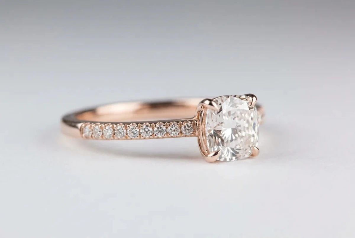 A polished rose gold diamond ring with a soft blush tone