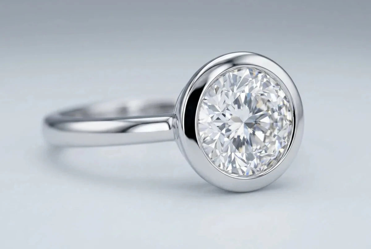 Bezel-set ring with a smooth metal rim encircling the diamond
