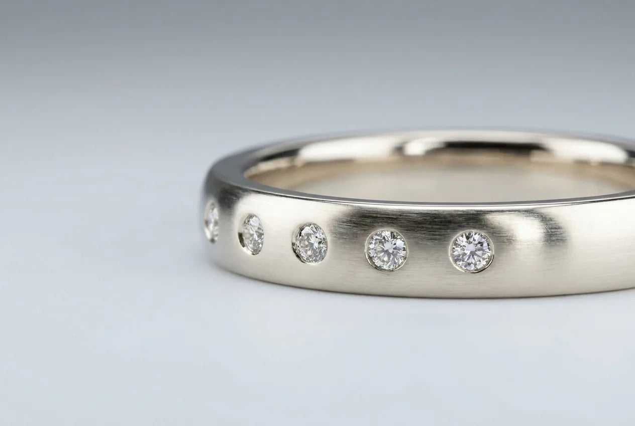 Wedding band with small diamonds flush-set level with the metal surface