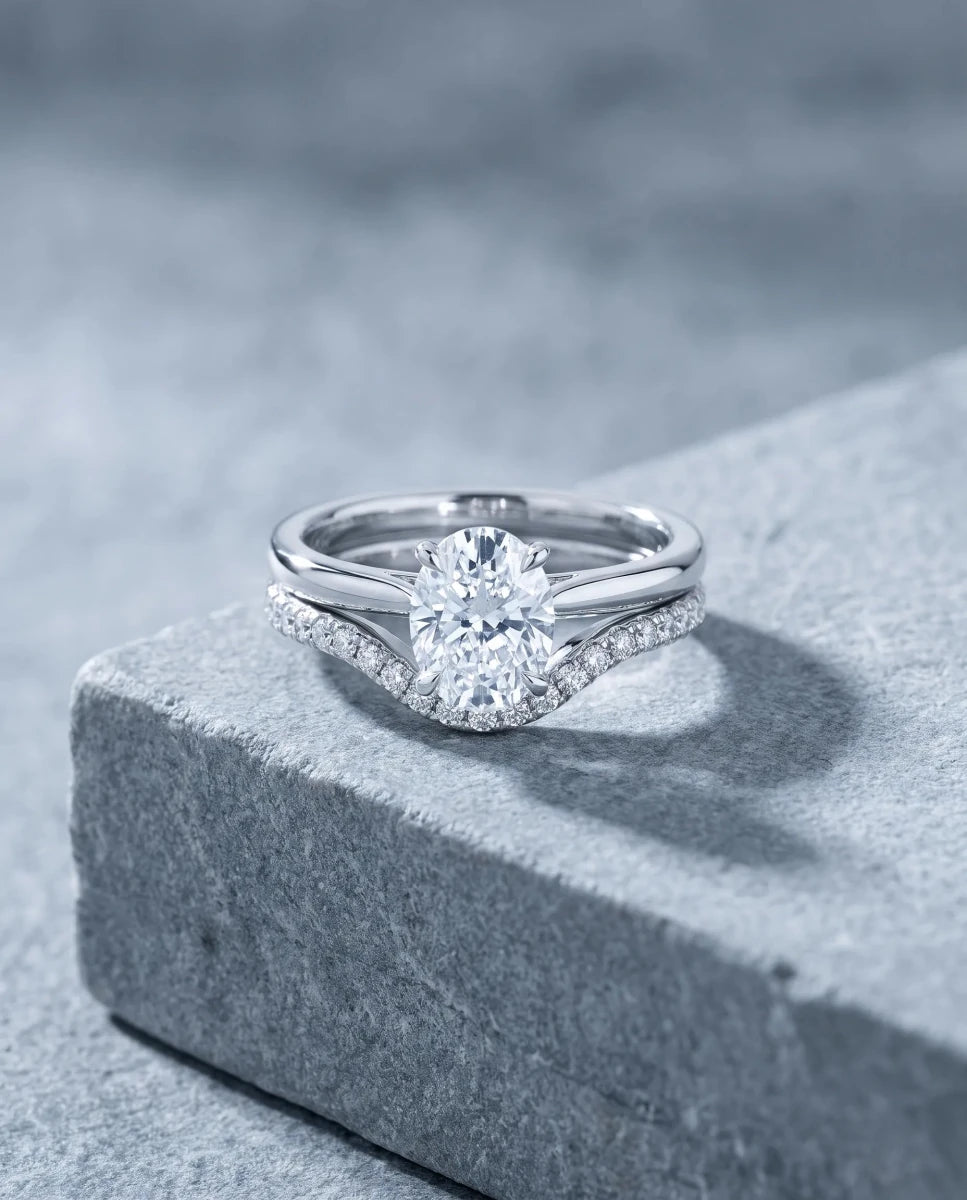 The finished contour diamond band nested flush against the oval solitaire