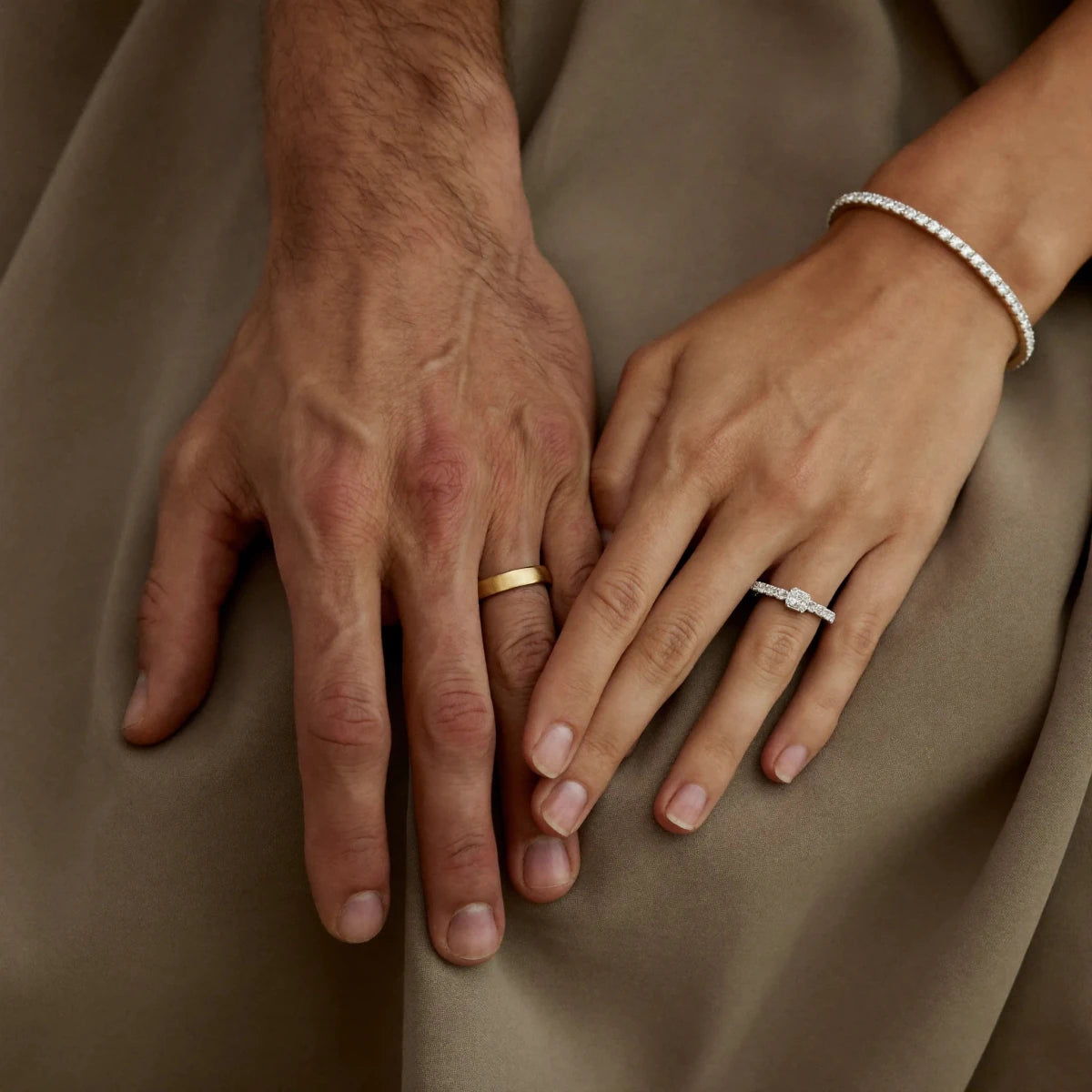 His and her hands wearing matching custom wedding bands