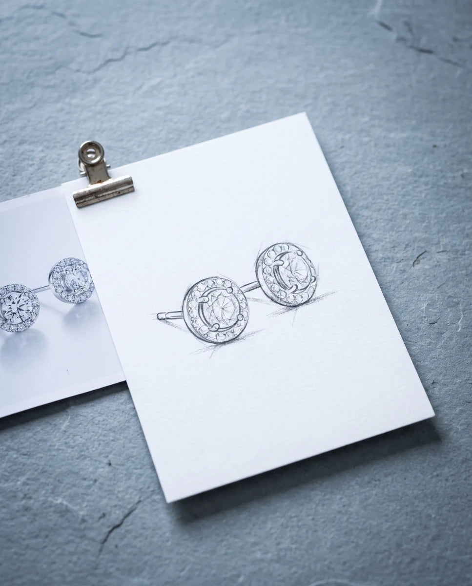A pencil sketch of halo stud earrings beside a printed inspiration photo