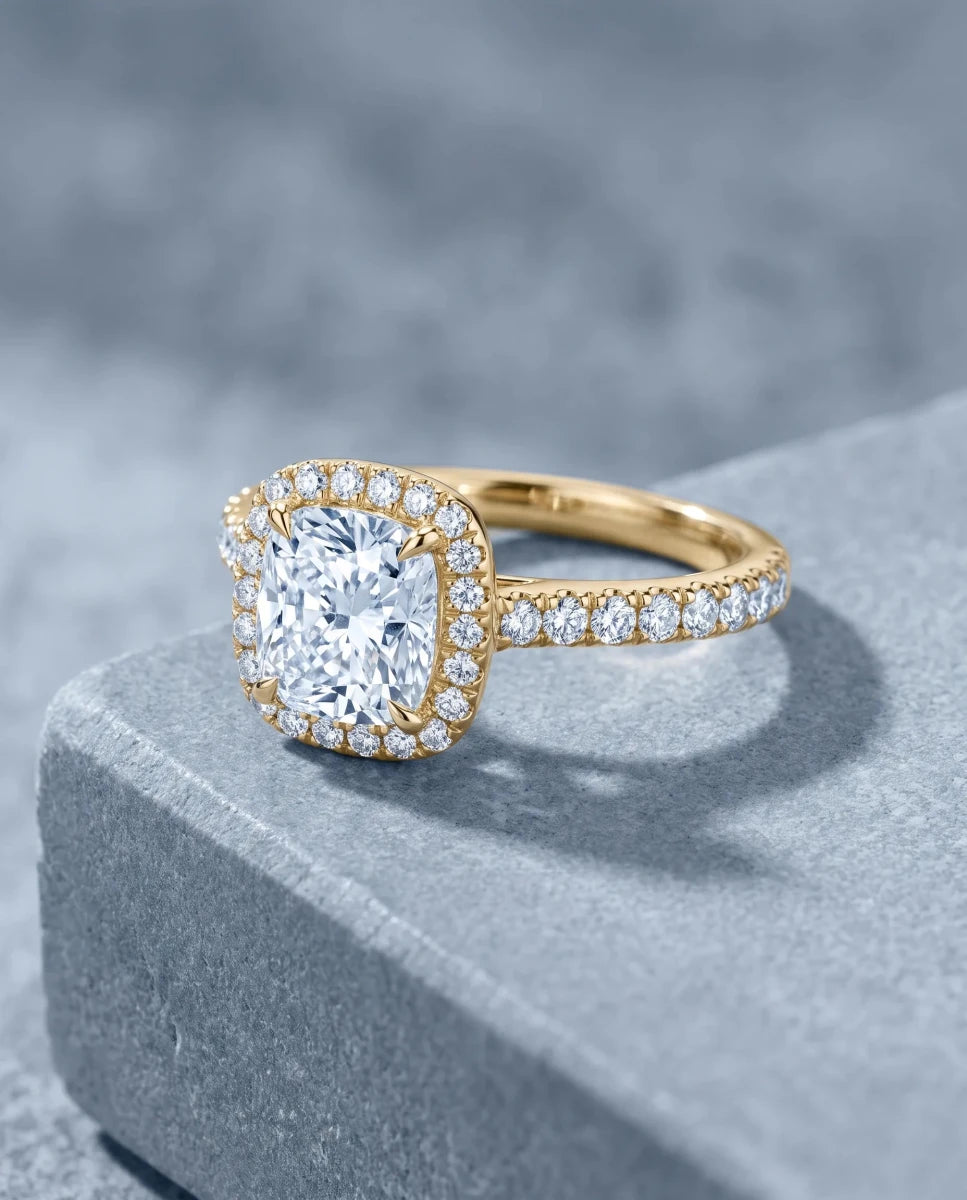 The finished cushion-cut halo engagement ring in yellow gold