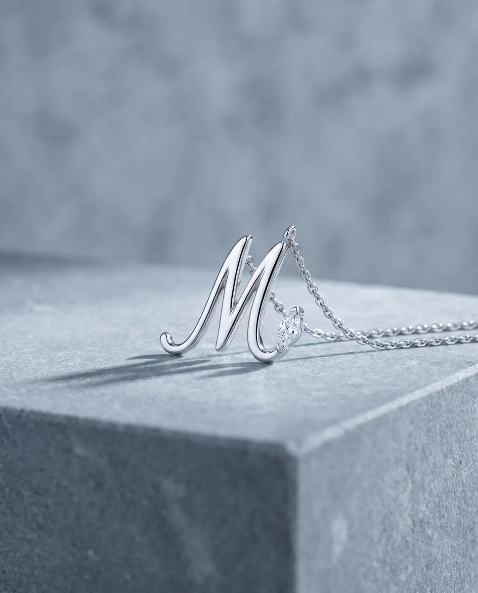 The finished diamond script initial pendant in white gold