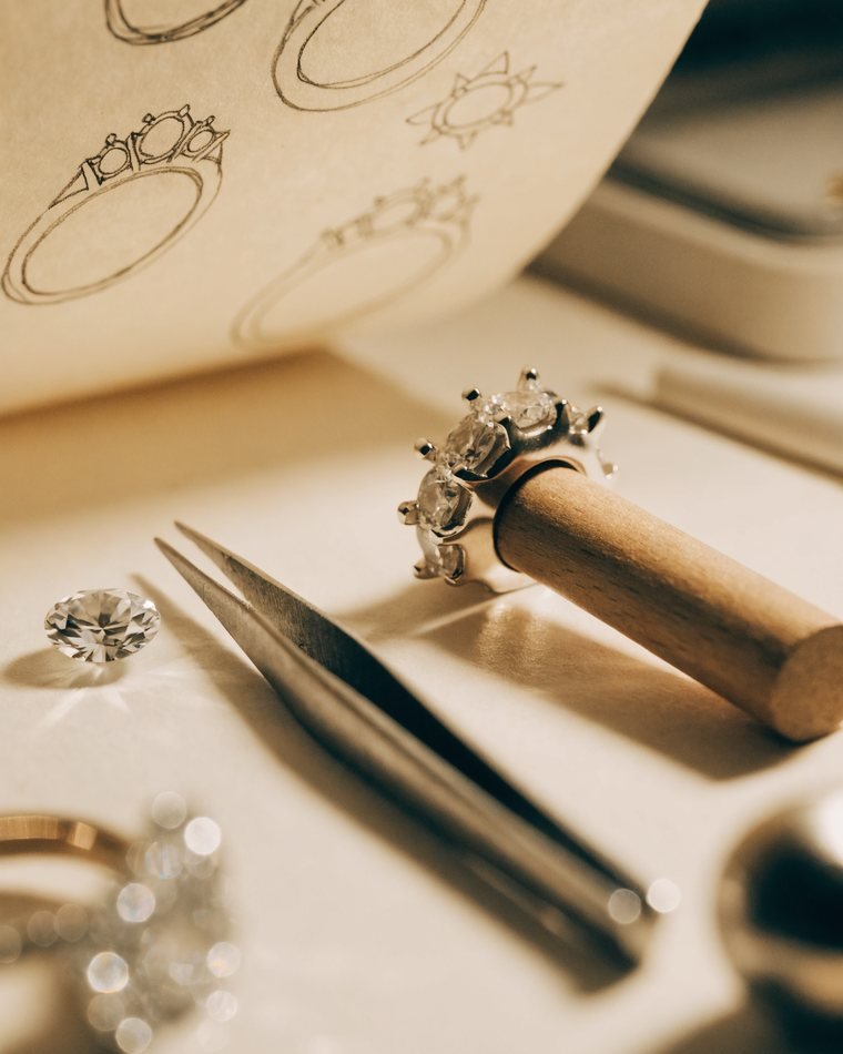 A jeweler setting diamonds at the bench in our US factory