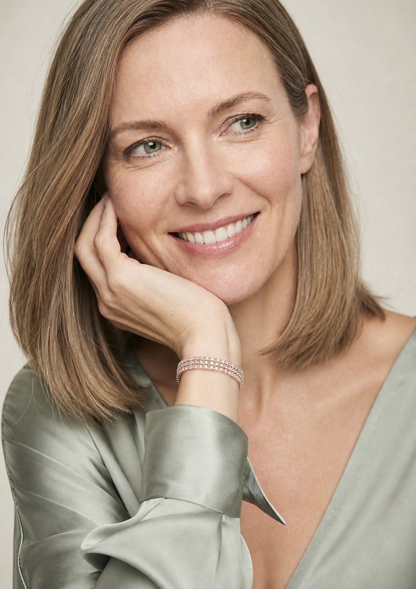 A woman wearing a rose gold diamond bracelet