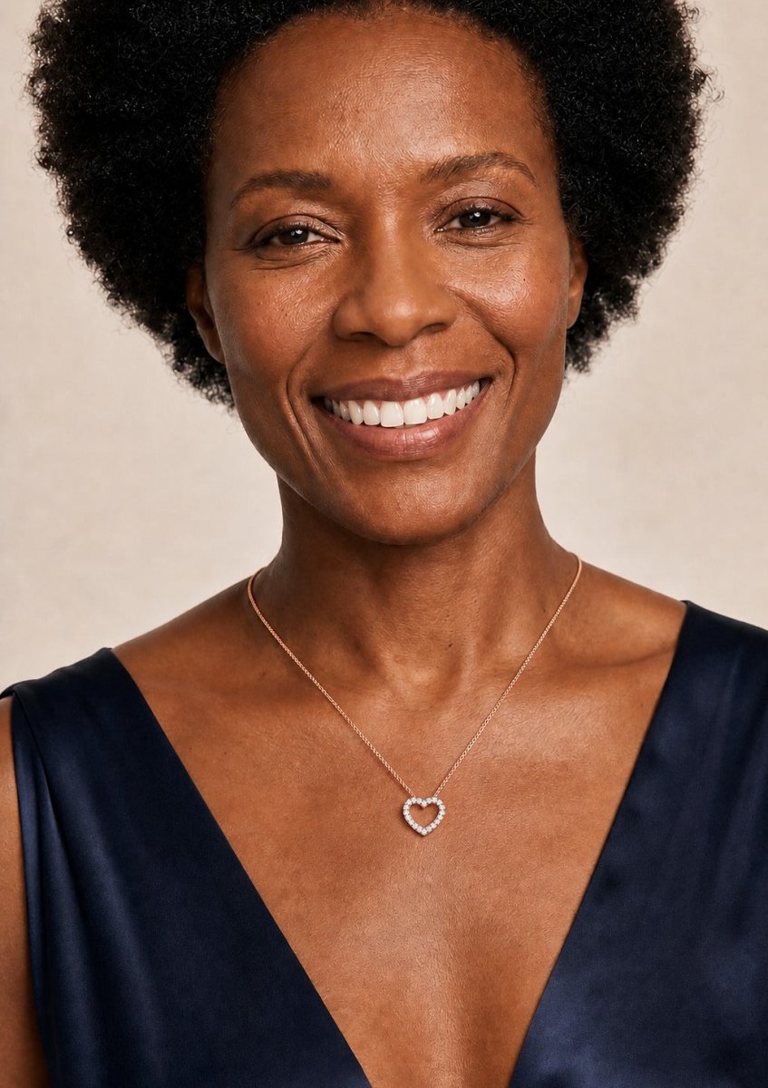A woman wearing a rose gold diamond pendant