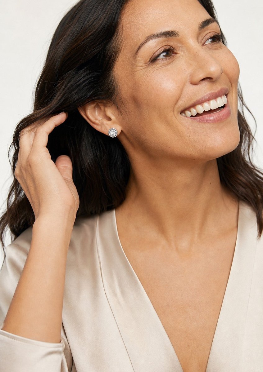 A woman wearing a white gold diamond pair