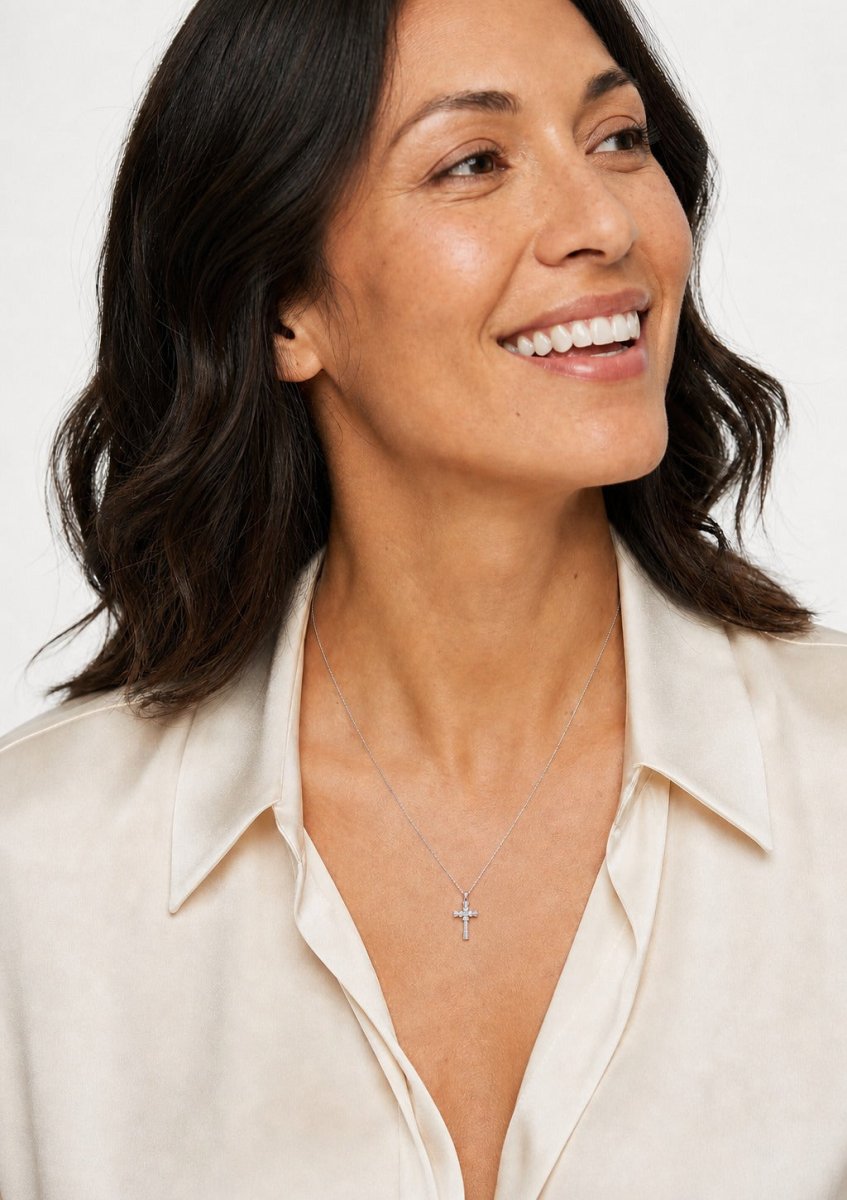 A woman wearing a white gold diamond pendant