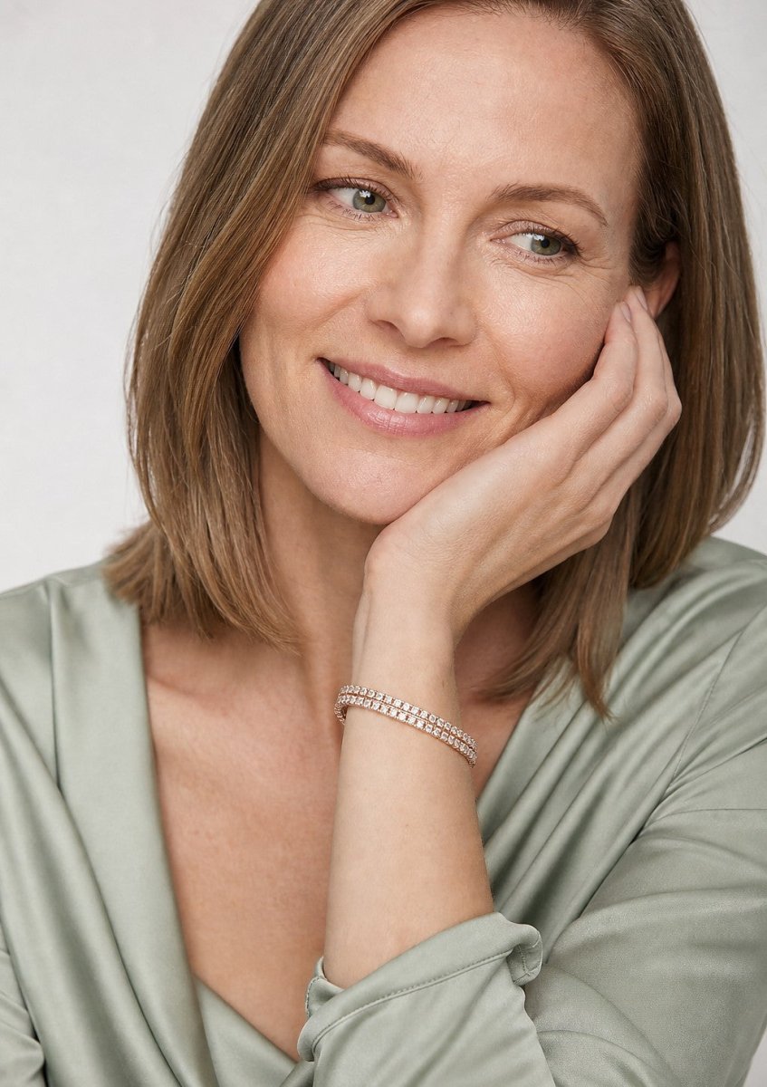 A woman wearing a yellow gold diamond bracelet
