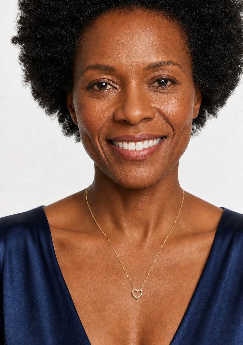 A woman wearing a yellow gold diamond pendant