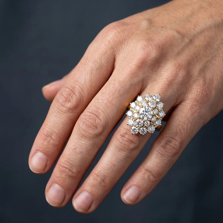 A woman's right hand wearing a bold diamond cocktail ring, no engagement ring on the other hand