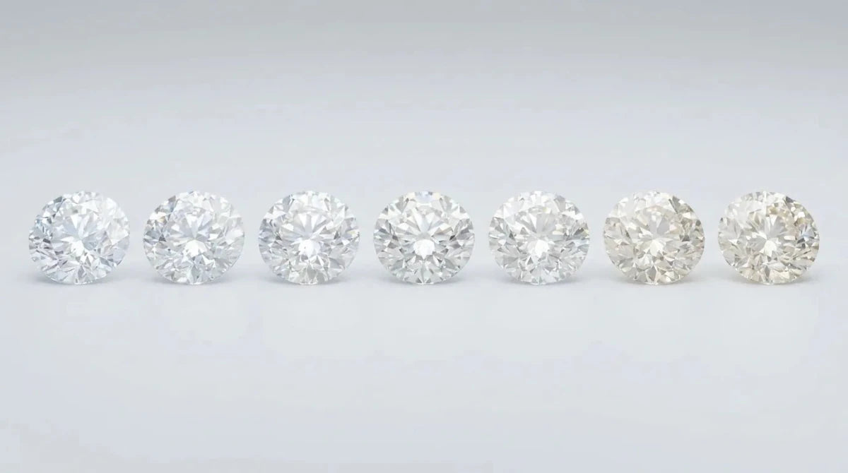A row of round diamonds shading subtly from icy colorless to faintly warm