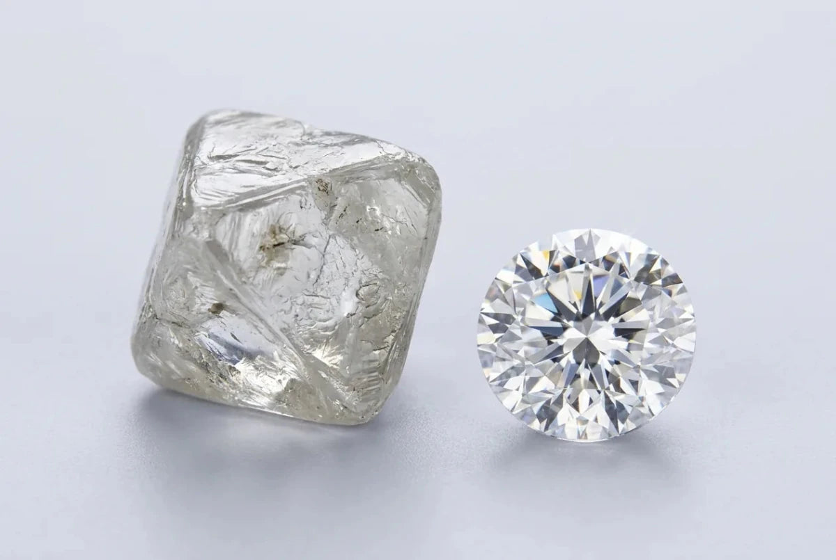 A rough diamond crystal beside a finished polished round brilliant diamond