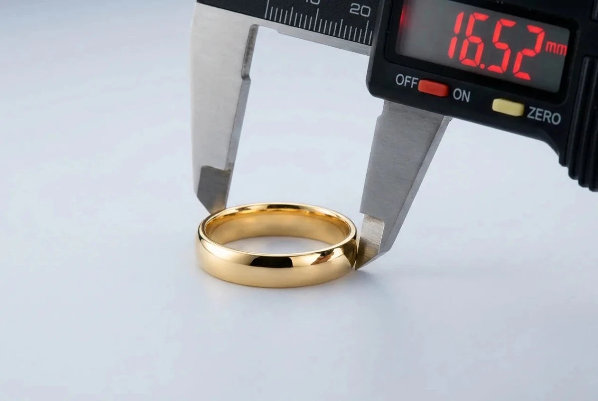 A gold band measured across its inside diameter with a caliper