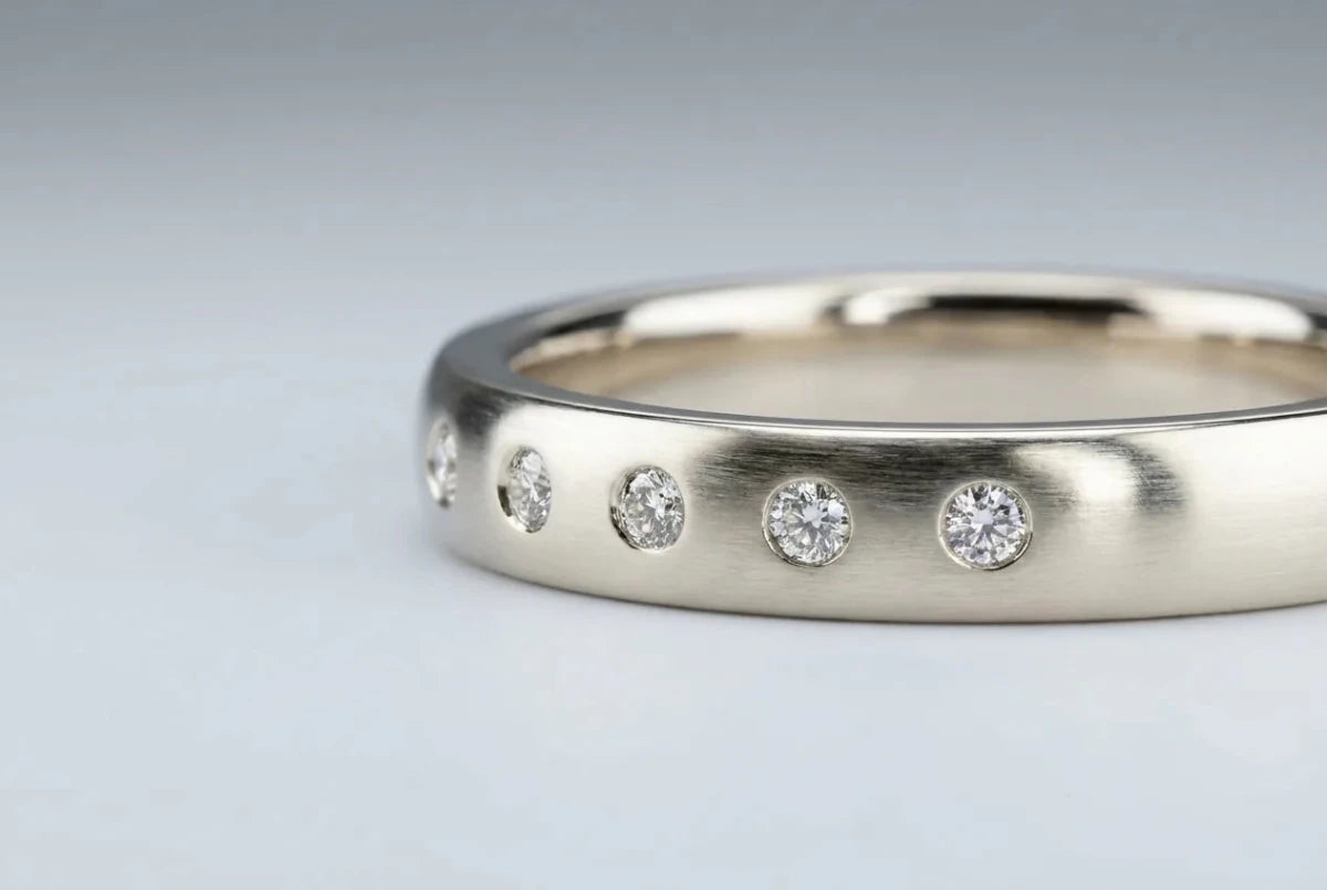 Wedding band with small diamonds flush-set level with the metal surface