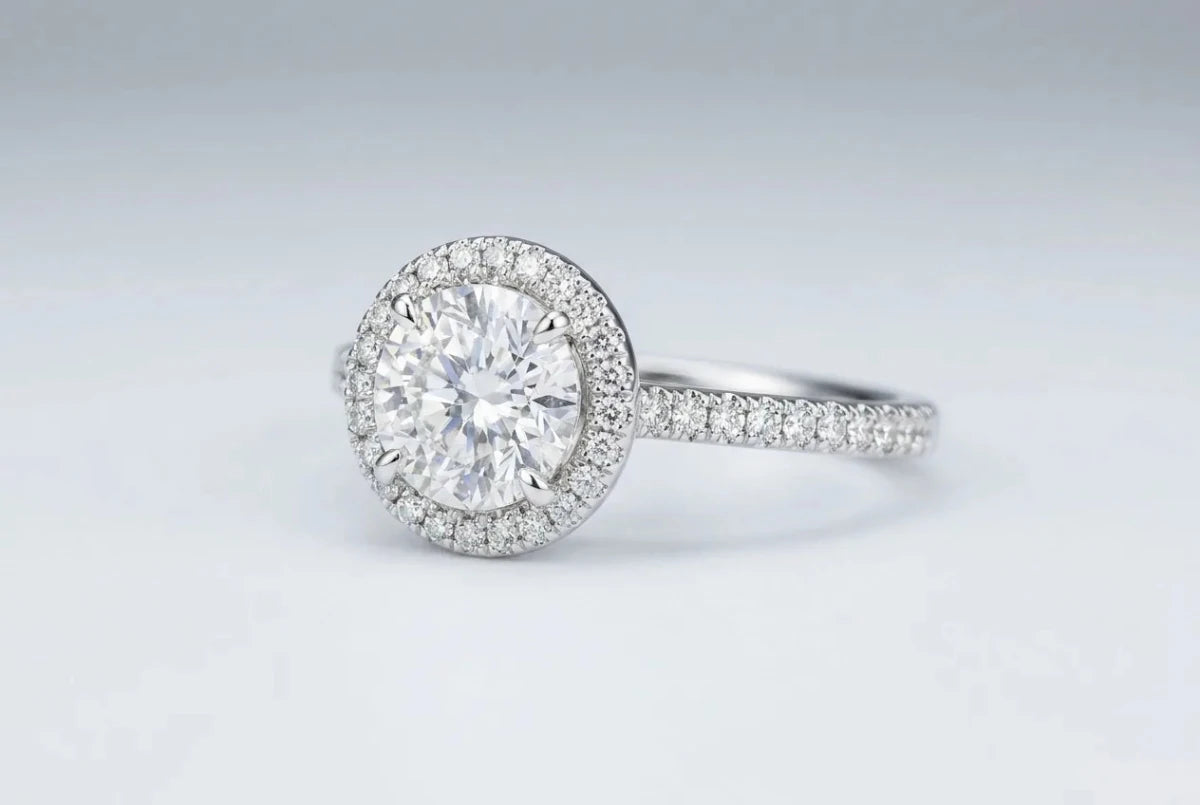 Halo ring with a center diamond encircled by small pavé diamonds