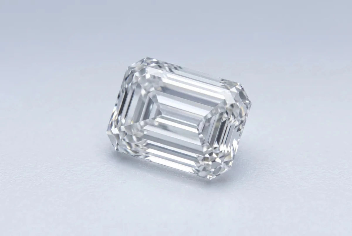 A loose emerald cut diamond with long stepped facets