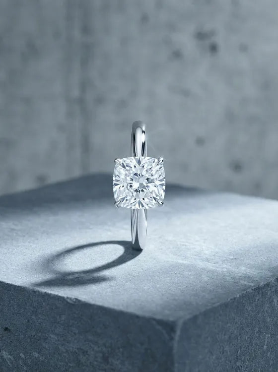 White gold solitaire ring with a cushion cut diamond