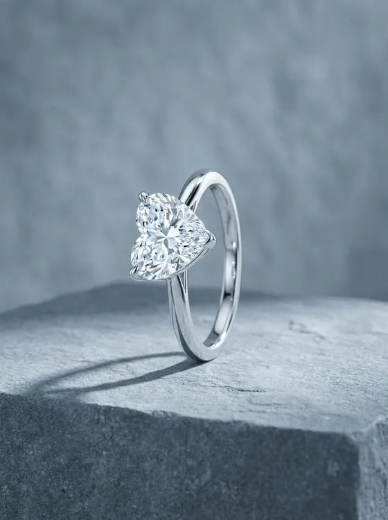 White gold solitaire ring with a heart shaped diamond