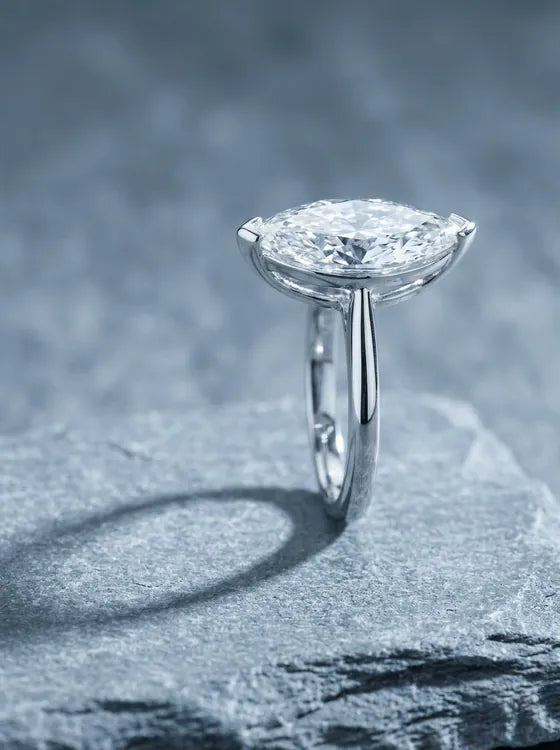 White gold solitaire ring with a marquise cut diamond