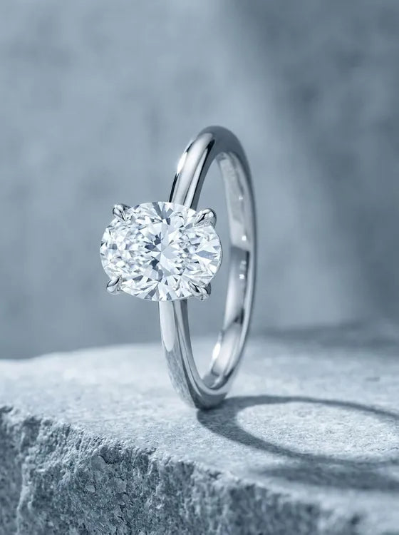 White gold solitaire ring with an oval cut diamond