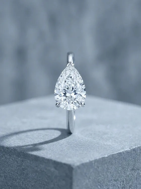 White gold solitaire ring with a pear cut diamond