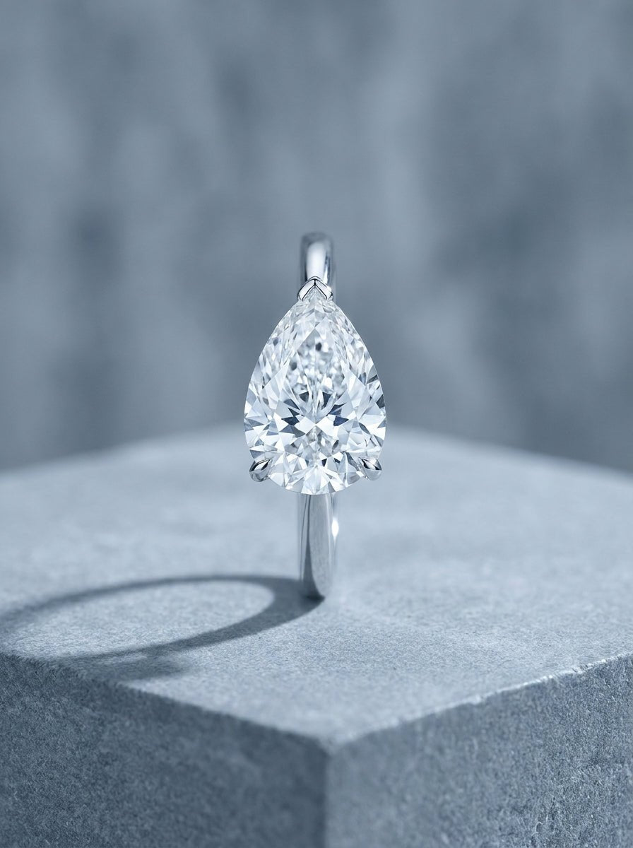 White gold solitaire ring with a pear cut diamond