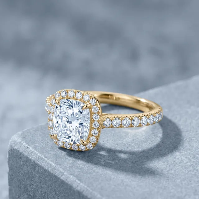 The finished cushion halo ring in yellow gold