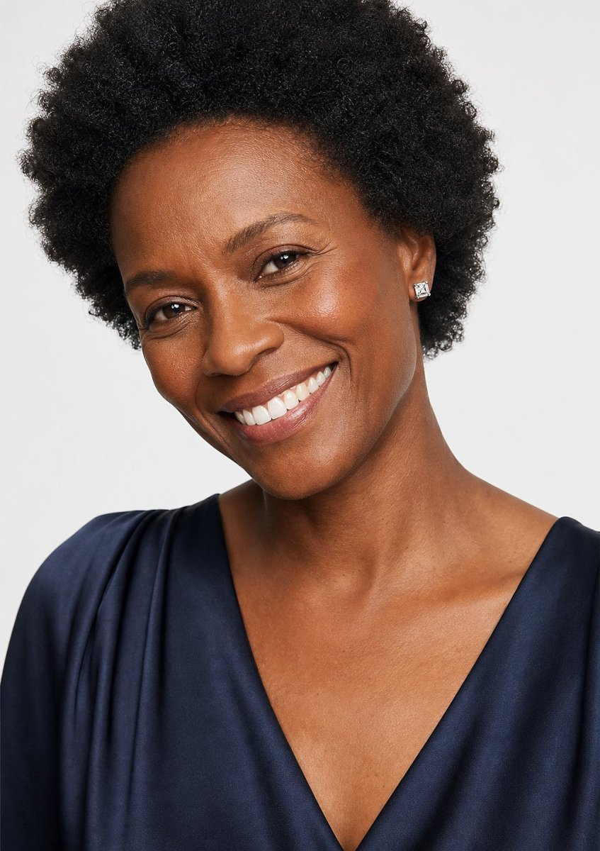A smiling woman wearing a white gold earrings set with square asscher cut, with cut corners and concentric step facets diamonds