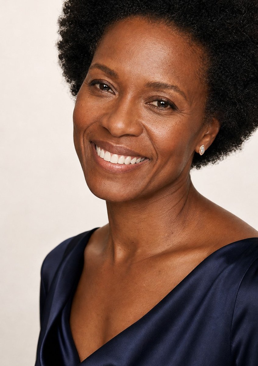 A smiling woman wearing a rose gold earrings set with long marquise cut, pointed at both ends diamonds